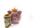 Pink piggy bank with golden crown and stack of US dollars in front isolated over white background with copy space