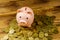 Pink piggy bank on heap of coins on wooden background. Saving money concept