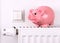 Pink piggy bank jump, saving electricity and heating costs