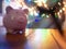 Pink piggy bank in night life. colourful burry light in background
