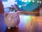 Pink piggy bank in night life. colourful burry light in background