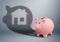 Pink piggy bank with shadow as home, savings for house finance c