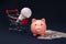 Pink piggy bank, trolley, money and light bulb, power savings concept