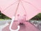 Pink Piggy bank with umbrella On a rainy day Saving money for any storm problem will come concept for finance, insurance,