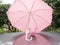 Pink Piggy bank with umbrella On a rainy day Saving money for any storm problem will come concept for finance, insurance,