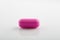 Pink pill on white