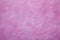 Pink plaster background - uneven rough surface