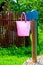 Pink plastic bucket and rural well