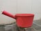 Pink plastic gayung or bucket, scoop, bailer,water dipper on the toilet floor.