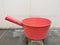 Pink plastic gayung or bucket, scoop, bailer,water dipper on the toilet floor.
