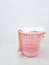 Pink plastic laundry basket and dirty towel in the laundry room