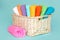 Pink plastic measuring vessel with washing powder, containers with detergent, stack terry towels