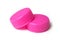 Pink plastic plugs for recycling on white background