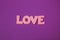 Pink plasticine and clay letters spelling the word Love