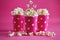 Pink polka dot paper cups with tasty popcorn.