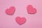 Pink polka dots background and hearts from wood