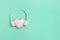 Pink polygonal paper heart shape in white headphones. Music concept. Dj Headset. Minimal style