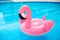 Pink pool float flamingo by blue water, pool party toy. Giant Inflatable Swimming Ring. Summer vacation holiday luxurious resort
