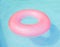 Pink pool float, ring floating in a refreshing blue swimming pool. Aquapark. Inflatable ring floating in pool on sunny day.Summer
