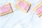 Pink pop tarts, shot from the top on a white marble background