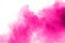 Pink powder explosion on white background.Pink dust splashing. Launched colorful particles on background