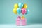 Pink present gift box with festive helium balloons bunch on aquamarine background