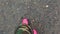 Pink puddle. Rain bright boots. Dirty safety shoes. Summer weather. Walking