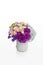 Pink and purple flower arrangement. Roses and hydrangea in a white vase designed for florist.