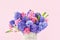 Pink and purple hyacinth bouquet in vase on a pink background. Mothers day, birthday concept