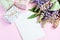 Pink, purple lupine flowers, gifts and empty paper sheet on pink background. Birthday, Mother`s day, Valentine`s Day, March 8,