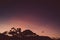 Pink purple and orange sunset over the mountains with eucalyptus gum trees silhouettes shot in Tasmania