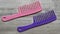 Pink and purple rake comb. Hair care.
