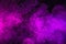 pink and purple smoke on black background as universe