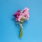 Pink purple statice flowers bouquet on blue background