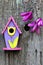 Pink, purple and yellow birdhouse