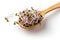 Pink radish sprouts on a wooden spoon on white background