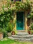 Pink rambling rose growing over green door of stone cottage