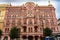 Pink and red historical building Bazin House in Russian style. Decorative facade with turrets, windows, stucco. Saint-Petersburg,