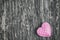 Pink retro heart with white polka dot pattern on wooden background with vintage and vignette tone