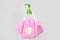 Pink reusable antiviral protective mask hanging on disinfectant white bottle with green dispenser