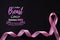 Pink ribbon on black paper background for supporting breast cancer awareness month campaign