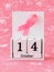 Pink ribbon of breast cancer awareness on a white wooden perpetual calendar with date 14 october. International breast cancer