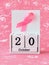 Pink ribbon of breast cancer awareness on a white wooden perpetual calendar with date 20 october. International breast cancer