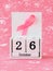 Pink ribbon of breast cancer awareness on a white wooden perpetual calendar with date 26 october. International breast cancer