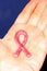 Pink ribbon on the hand. World Breast Cancer Day.