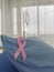 Pink ribbon with hospital bad for patient in health care facility. Breast cancer symbol