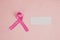 Pink ribbon beside a piece of transparent paper