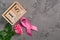 Pink ribbon, rose and wooden cube calendar set for October 15 on a concrete surface. Breast Cancer Awareness Month