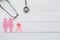 Pink ribbon and stethoscope on white wooder background, Symbol of breast cancer in women, Health care concept