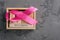 Pink ribbon and wooden cube calendar set for October 15 on a concrete surface. Breast Cancer Awareness Month